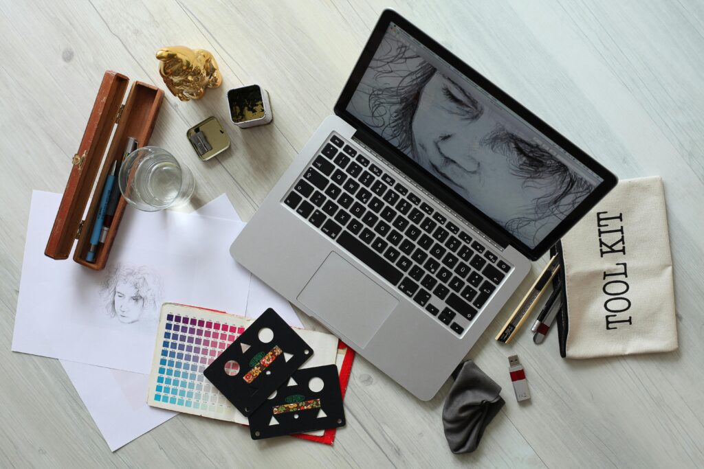 image of a computer and tools such as paper or pen illustrating a typical workspace